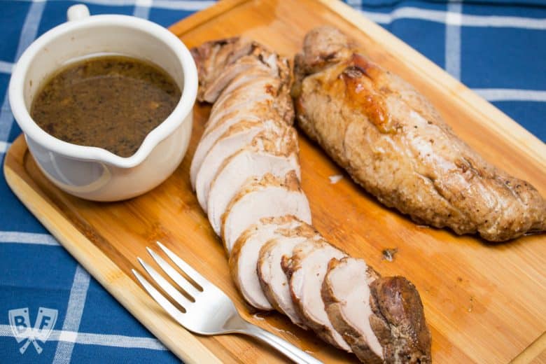 Overhead view Balsamic Marinated Pork Tenderloin carved on a cutting board.