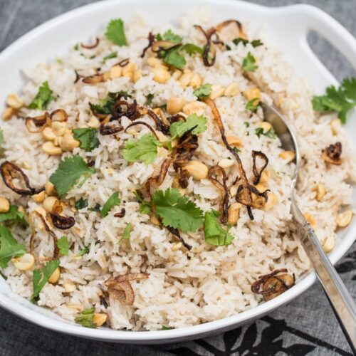 ¾ view of a bowl of Peanutty Rice with Crispy Fried Shallots.