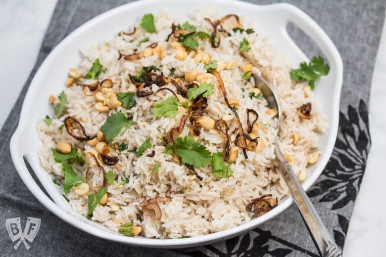 ¾ view of a bowl of Peanutty Rice with Crispy Fried Shallots.