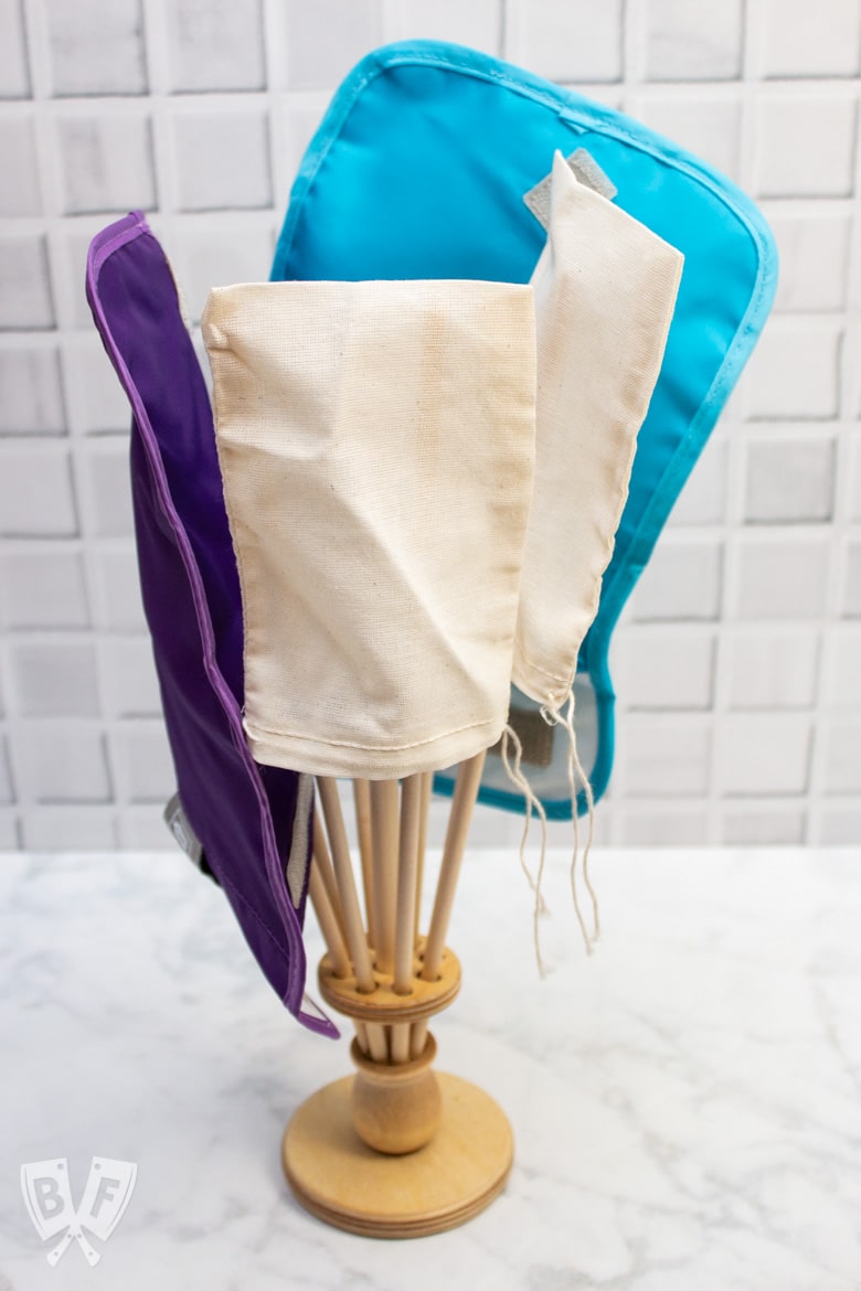 Side view of a wooden bag dryer holding reusable bags.