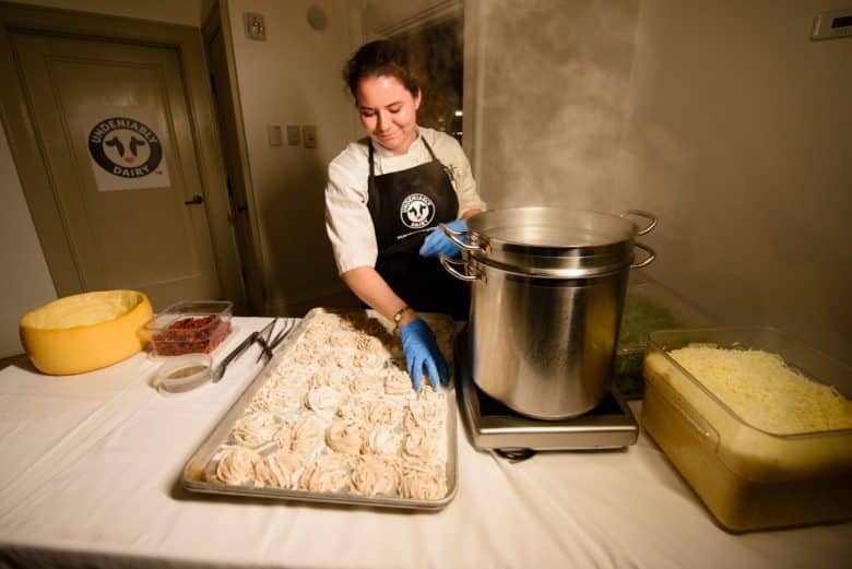 A chef preparing fresh pasta for a large crowd.