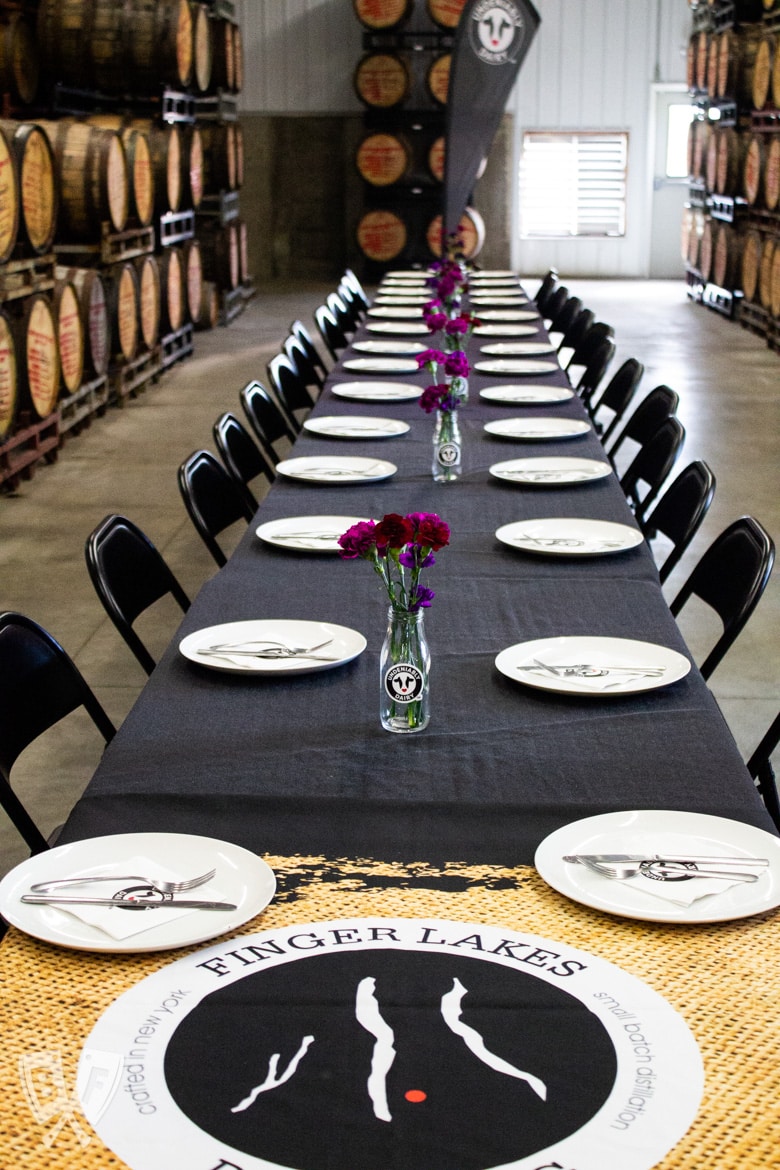 Table set for lunch in the barrel room of Finger Lakes Distilling