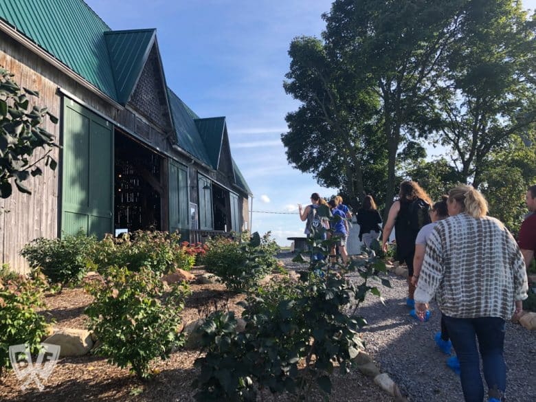 Group of people walking up to a barn.