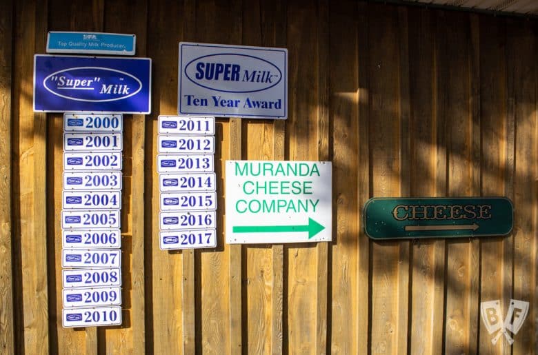 Cheese award plaques on the side of a barn at Muranda Cheese Company.