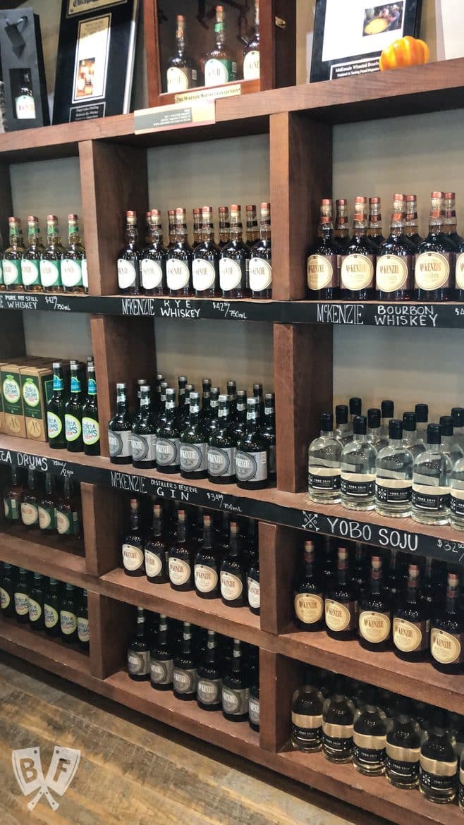 Shelves full of bottles of spirits at a distillery.