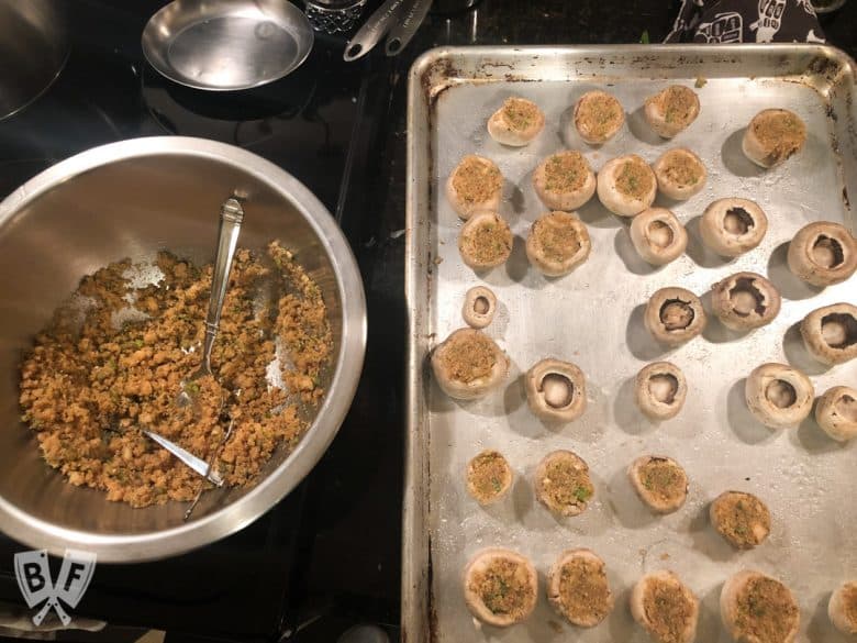 Stuffing mushroom caps full of an Italian bread crumb mixture.