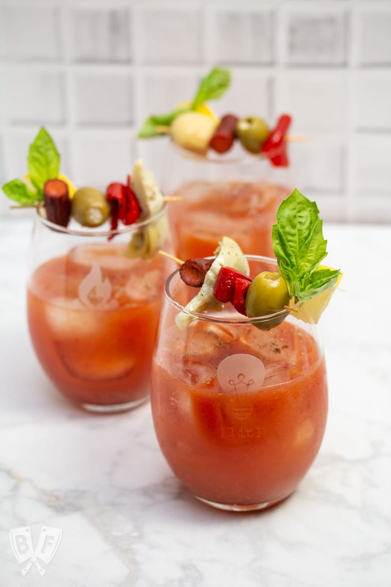 3 Bloody Mary cocktails garnished with Italian antipasto ingredients.