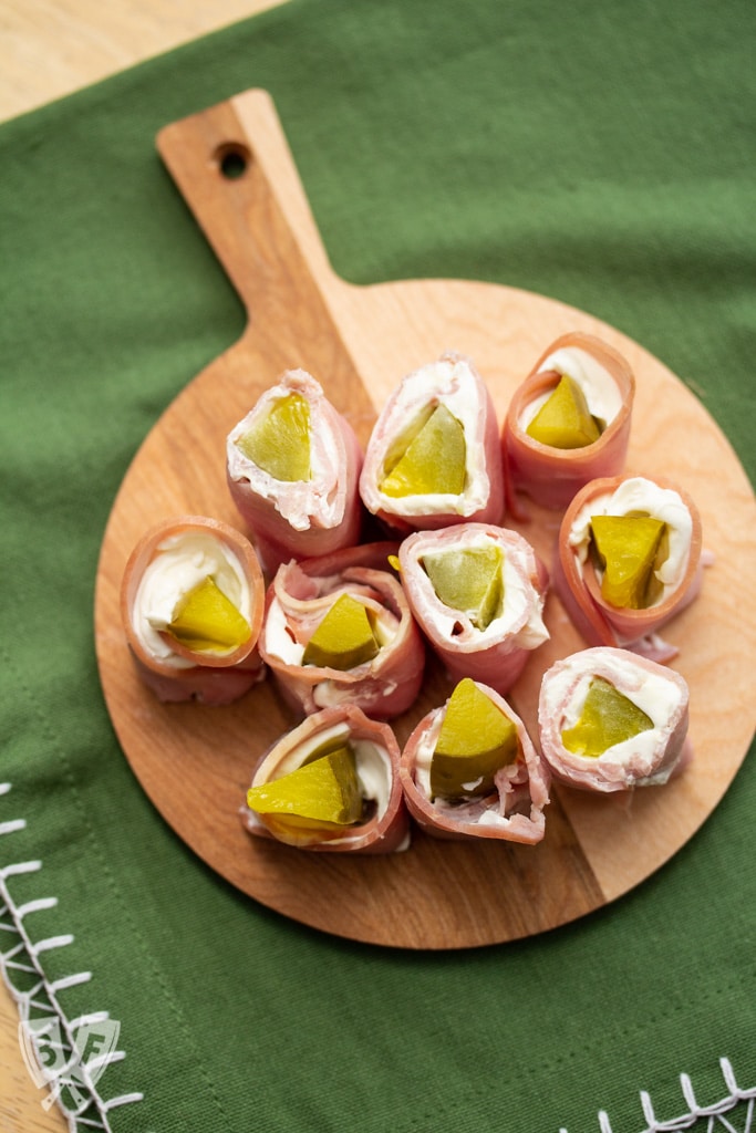 Small cutting board filled with sliced pickle treat appetizers.