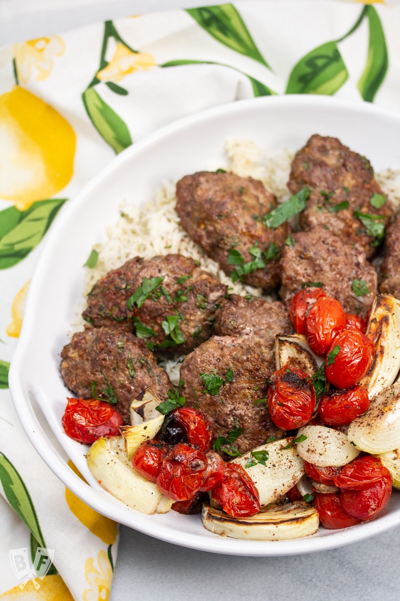 Overhead view of Broiler Kebab Sheet Pan Meal served in a bowl over rice