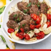 Platter of Persian broiler kebab with tomatoes, onions, and rice.