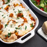 Baked rigatoni pasta casserole with Parmesan and a salad on the side.