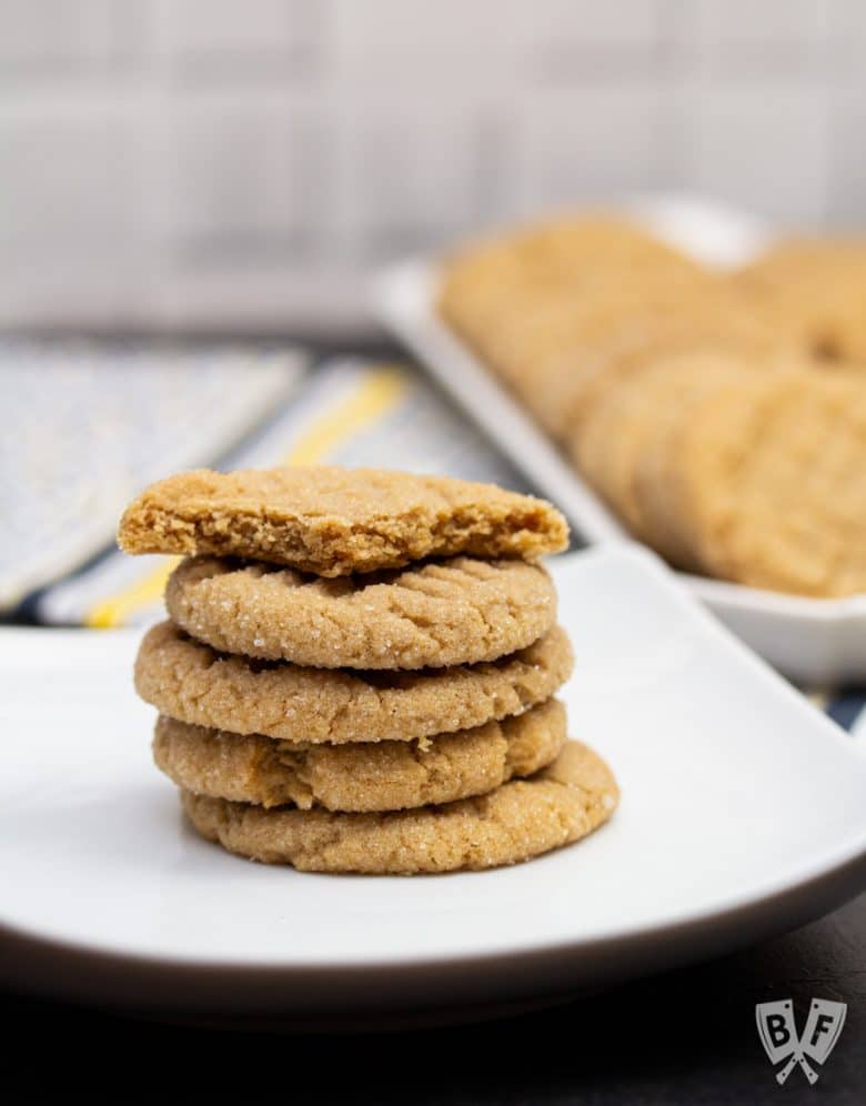 A stack of peanut butter cookies - the top one has been bitten