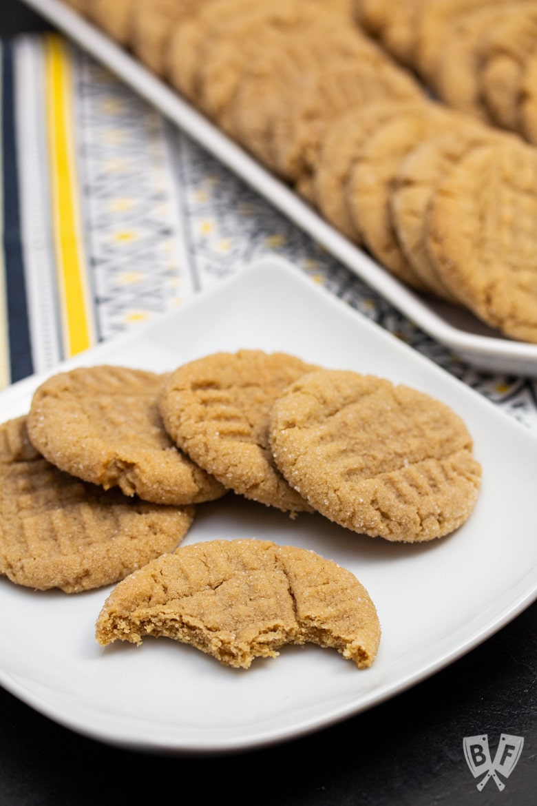 Plate of peanut butter cookies with bites taken out of one