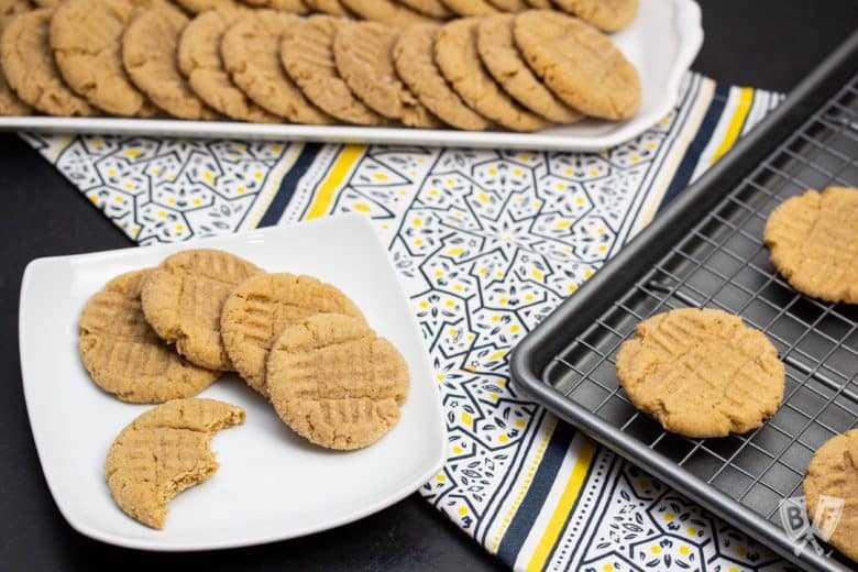 Peanut butter cookies on a platter, plate, and baking sheet