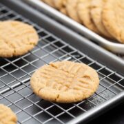 Peanut butter cookies cooling on a baking sheet