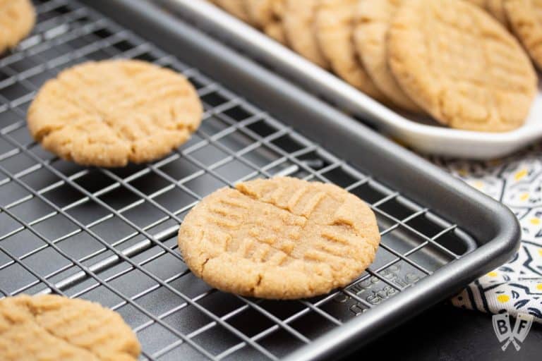 Peanut butter cookies cooling on a baking sheet