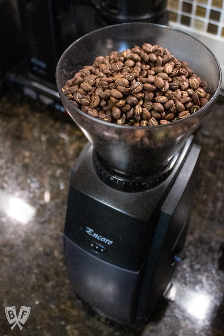 Coffee beans in a burr grinder to use for making cold brew coffee