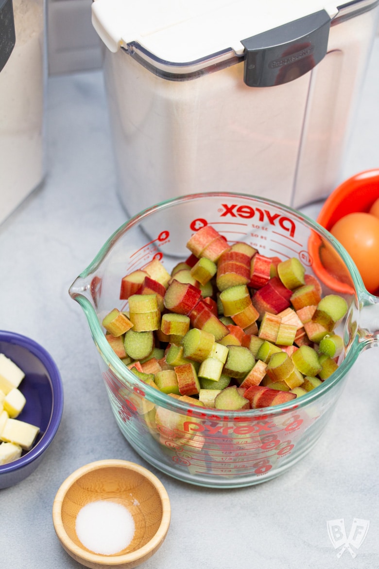 Chopped rhubarb along with other ingredients for making rhubarb custard pie.