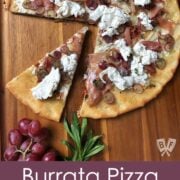 Overhead view of a slice cut out of a Burrata Pizza with Prosciutto and Pickled Grapes