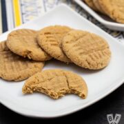 Plate of peanut butter cookies with bites taken out of one