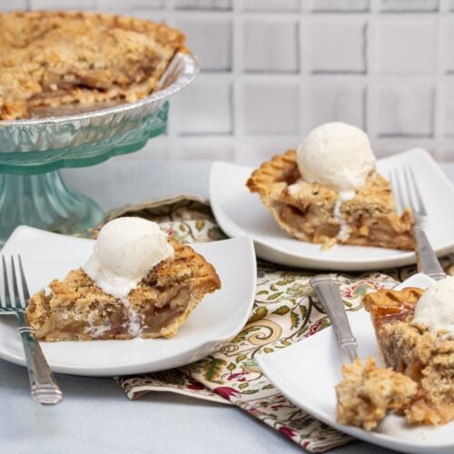 Plates with slices of Dutch apple pie topped with ice cream