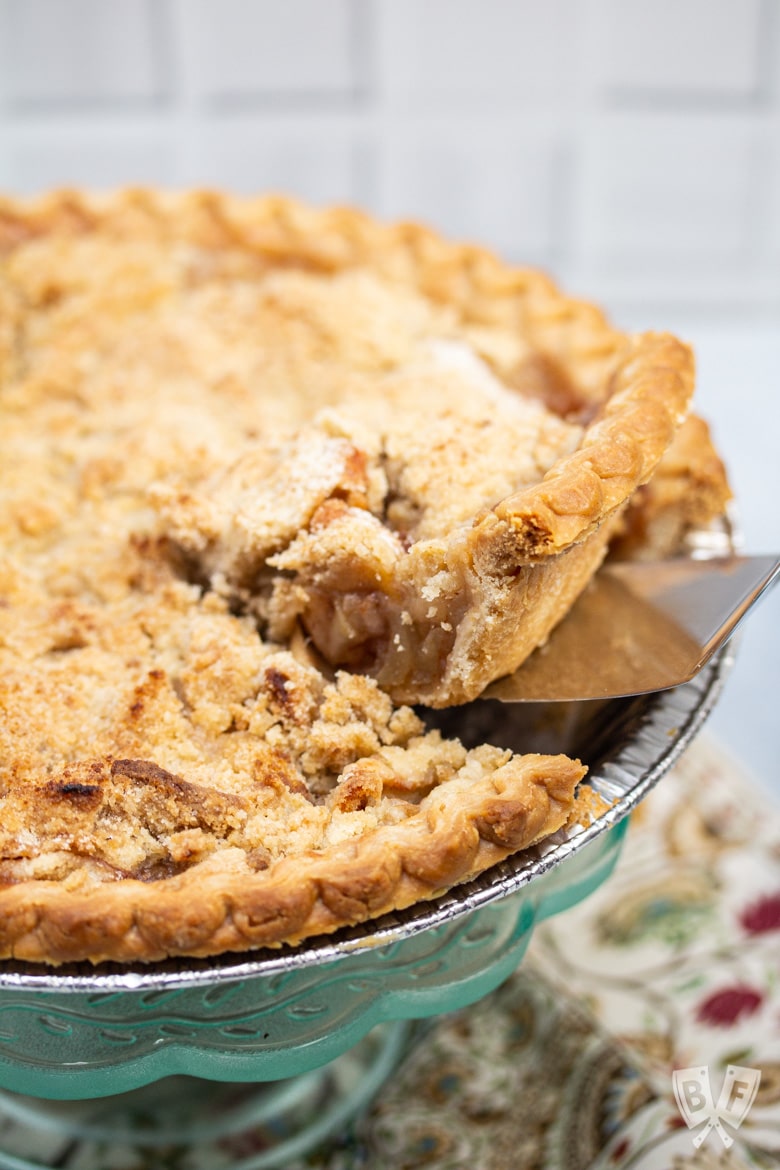 Removing a slice of Dutch apple pie from the pie plate.