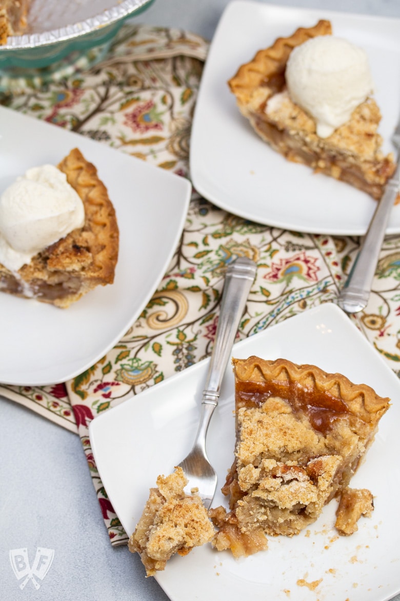 Overhead view of 3 slices of Dutch apple pie with ice cream on some