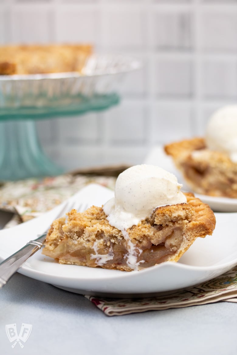 Side view of a slice of Dutch apple pie a la mode