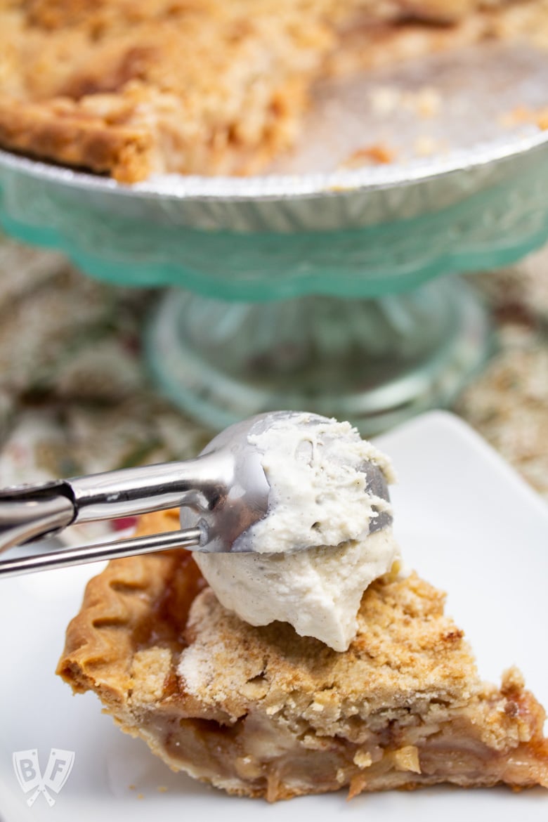 Scooping vanilla ice cream onto Dutch apple pie