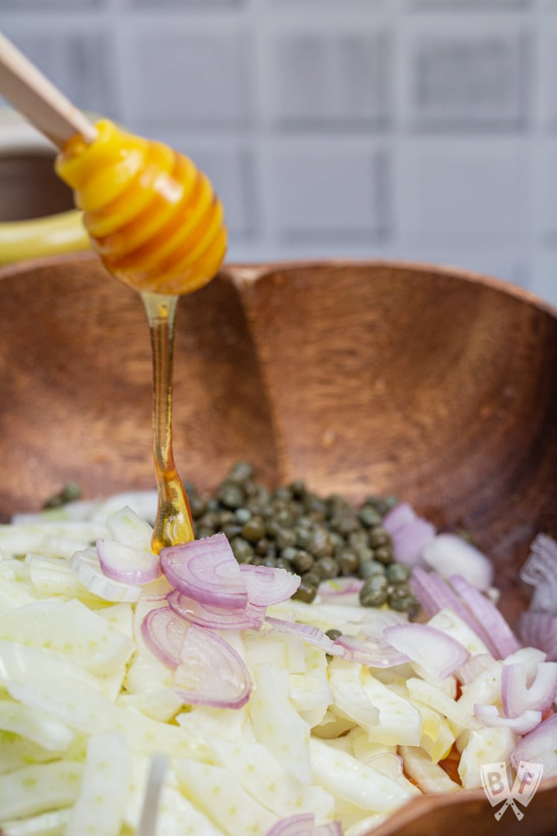 Drizzling honey onto a fresh fennel salad.