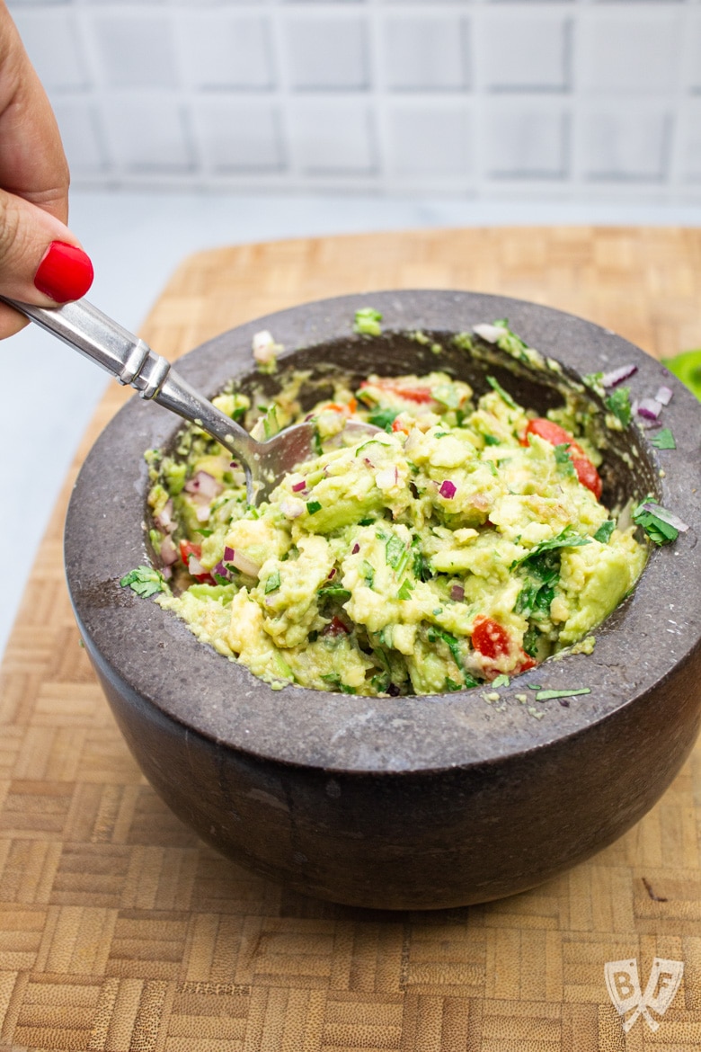 Stirring guacamole ingredients together.