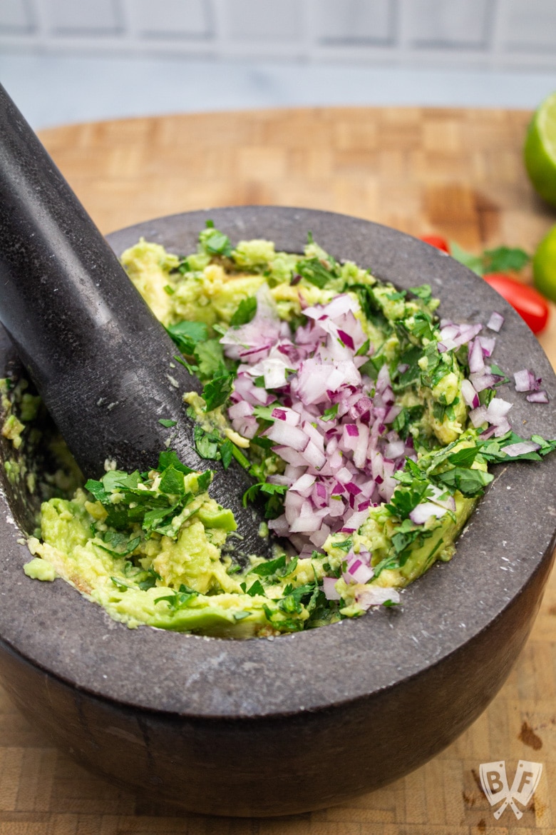 Using a mortar and pestle to make homemade guacamole.