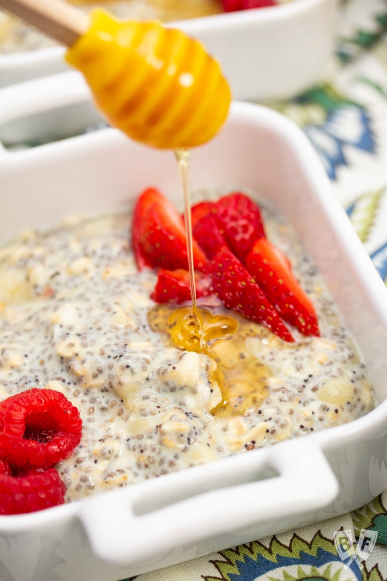 Drizzling honey onto a bowl of Lemon Poppy Seed CBD Chia Pudding