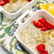 Overhead view of bowls of Lemon Poppy Seed CBD Chia Pudding garnished with fresh berries and honey