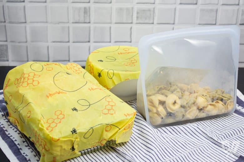 Beeswax wrap being used to cover dishes in an environmentally friendly manner