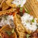 Overhead view of a skillet lasagna with lamb, ricotta, and mint.