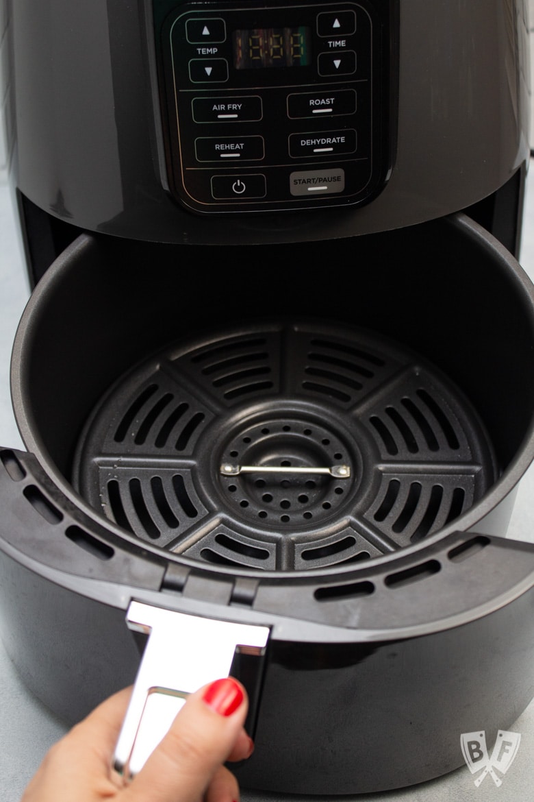 Pulling the drawer out of a Ninja air fryer