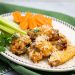 Plate of air fryer garlic parmesan chicken wings with carrots and celery.