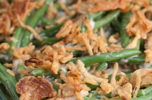 Casserole dish full of green bean casserole for Thanksgiving