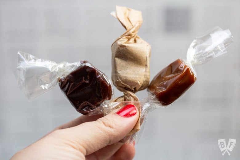 Holding 3 varieties of small batch caramels