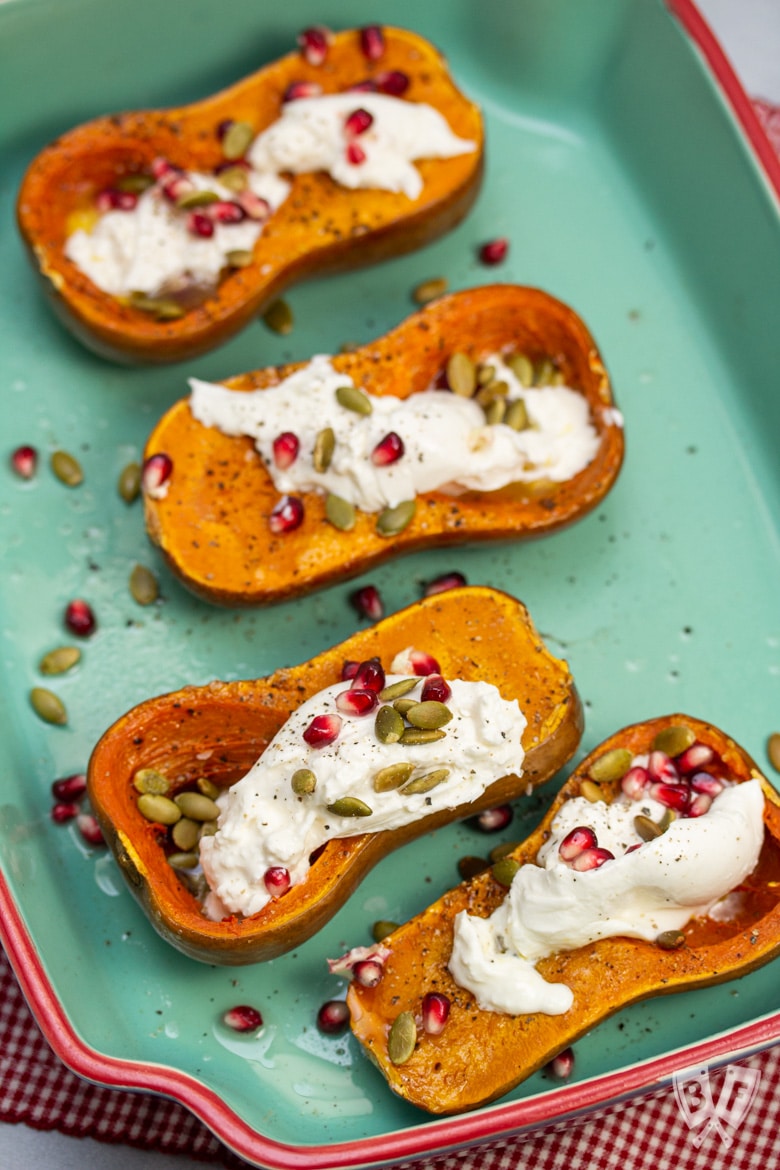 Overhead view of Roasted Honeynut Squash with Burrata, Pomegranate + Pepitas