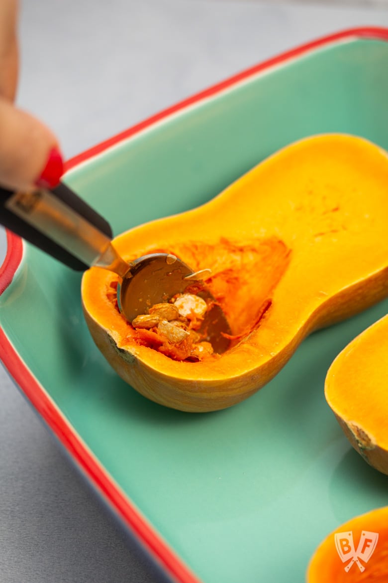 Scooping seeds out of a honeynut squash