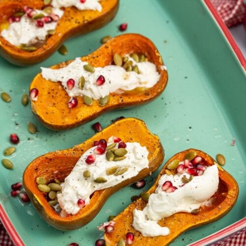 Roasted Honeynut Squash with Burrata, Pomegranate + Pepitas in a baking dish
