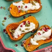 Overhead view of Roasted Honeynut Squash with Burrata, Pomegranate + Pepitas