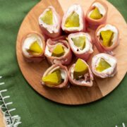 Small cutting board filled with sliced pickle treat appetizers.