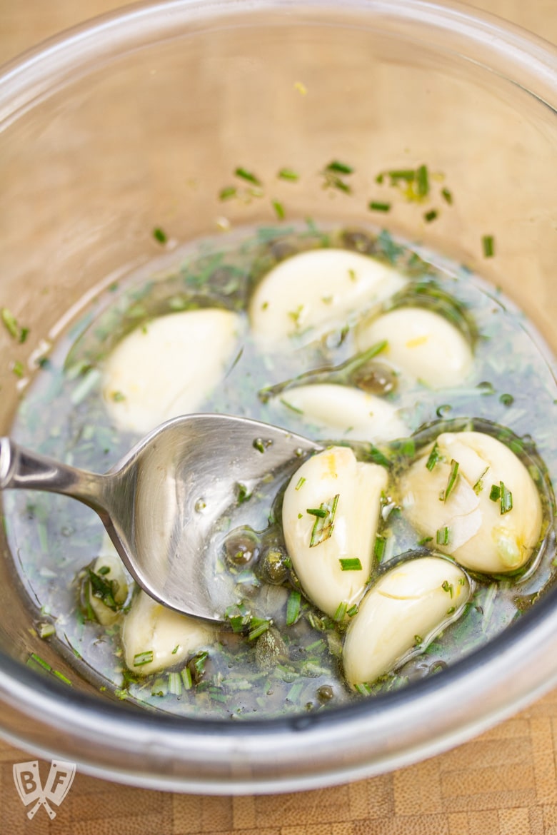 Bowl with a mix of garlic, rosemary, and olive oil