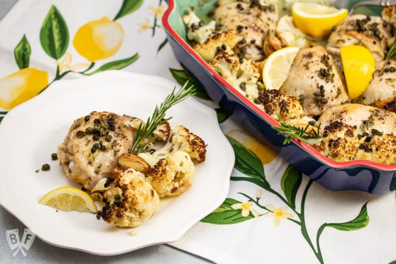 Plate of keto lemon-rosemary chicken next to a baking dish