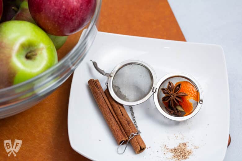 Whole spices in a tea ball for infusing mulled cider applesauce.