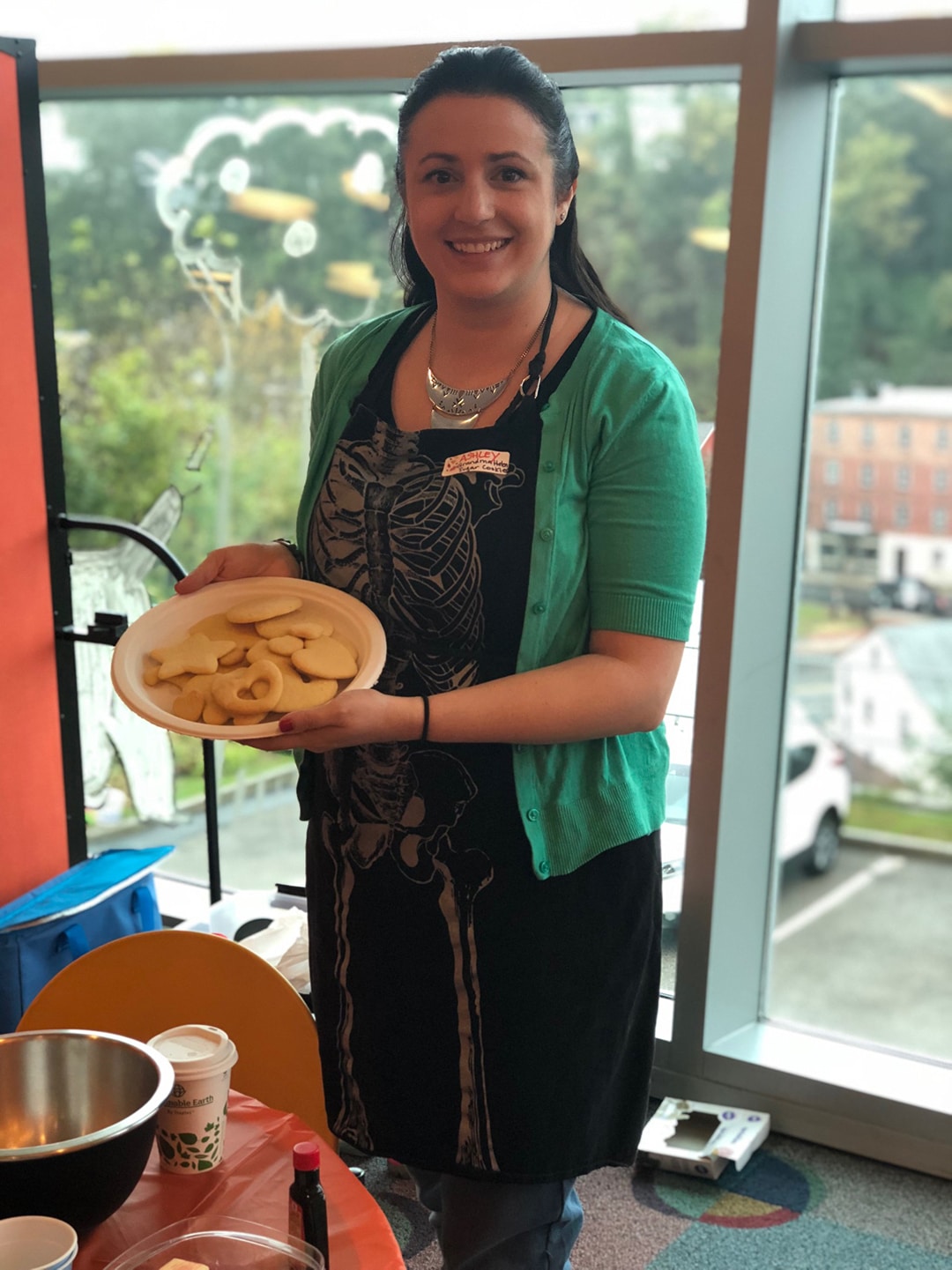 Ashley Covelli holding a plate of cookies for a decorating class at the library.