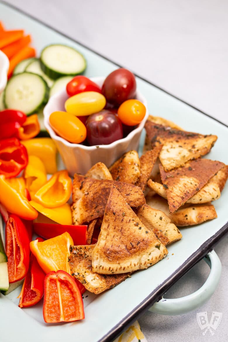 Platter of colorful veggies and pita chips.